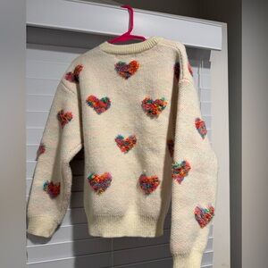 Girls cream sweater with hearts.